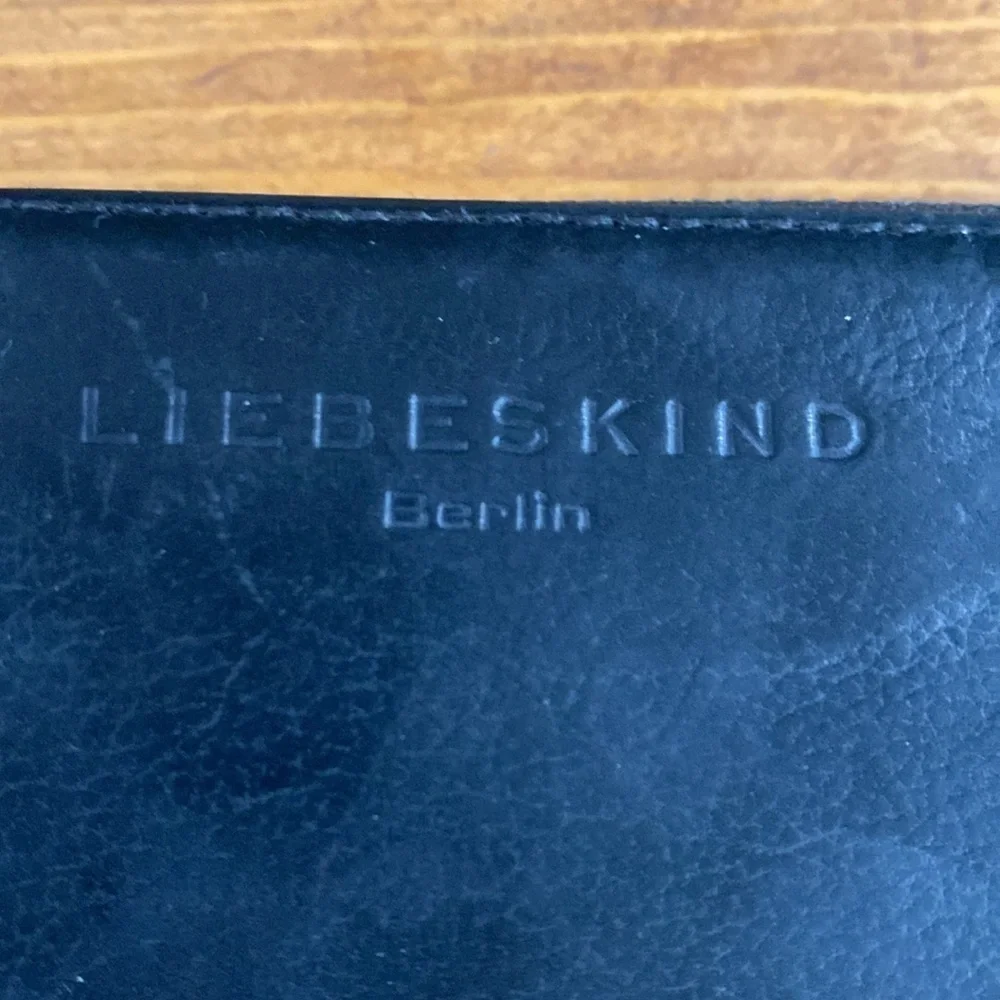 Liebeskind leather wallet full zipper closure tassel pull neutral black minimal